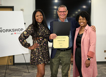 A man presenting two women with a Carolina York Certificate of Completion