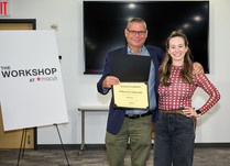 A man presenting a woman with a Forgotten Skincare Certificate of Completion