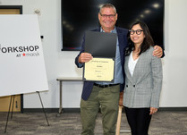 A man presenting a woman with a Maika Certificate of Completion
