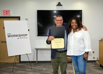 A man presenting a woman with a Swanky Designs Certificate of Completion