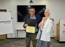 A man presenting a woman with an Abingdon Co Certificate of Completion