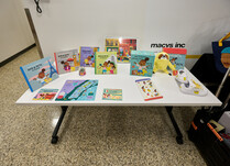 Aya and Pete children's books and other products on a table