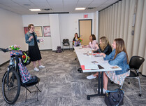 A woman presenting to a workshop panel 