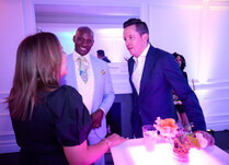 A group of 3 attendees talking with each other