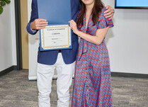 A man presenting a woman with a Cardon Certificate of Completion