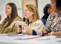 A woman addresses presenter workshop