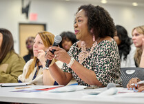 A woman addresses presenter workshop