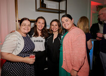 Four women smiling for a photo