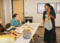 Workshop attendee shows bag to panel