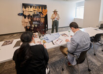 Workshop attendee talks about Naked Rebellion with panel