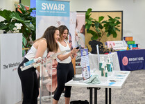 Two women presenting SWAIR products to workshop