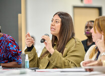 A woman addresses presenter workshop