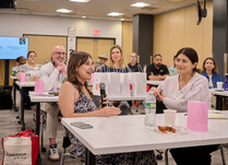 A workshop attendee with a microphone speaks during the workshop