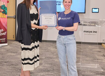 A woman presenting an attendee with a Bright Girl Certificate of Completion