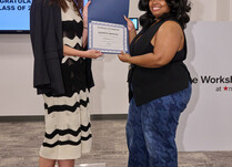 A woman presenting another woman with a Jazmine Kionna Certificate of Completion