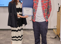 A woman presenting a man with a Rockbridge Certificate of Completion
