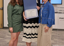 A woman presenting two people with a SWAIR Certificate of Completion