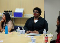 A woman addressing other attendees