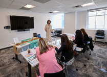 A woman presenting to a workshop panel 