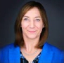 A person in a blue jacket  Description automatically generated